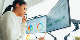 female worker looking at data screens